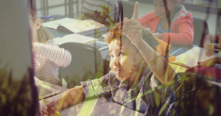 In school, young boy raising hand eagerly in classroom, actively participating. Education, back to school, learning, studying, student, enthusiasmの写真素材
