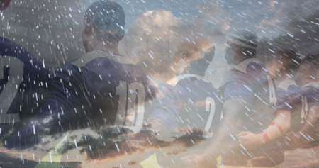 Rugby players huddling on field, preparing for match under dramatic sky. Teamwork, sport, athletes,...