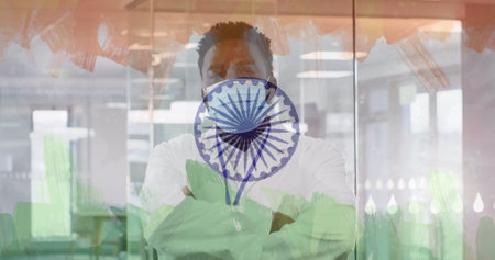 Image of male doctor wearing face mask over indian flag. global covid 19 pandemic and indian healthcare crisis concept digitally generated image.の写真素材
