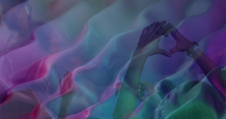 Hands forming heart shape at concert, vibrant lights creating abstract background. music festival, audience, excitement, celebration, neon, nightの写真素材