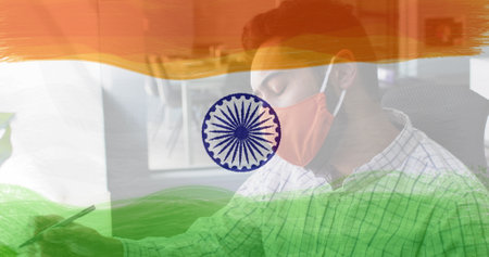 Composition of man wearing face mask over indian flag. global coronavirus pandemic and indian healthcare crisis concept digitally generated image.の写真素材