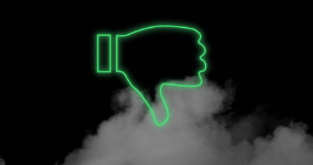 Image of neon thumbs down icon flickering over smoke on black background. social media, digital interface and communication concept digitally generated image.の写真素材