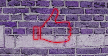 Neon red thumbs up sign glowing against purple brick wall background. vibrant, lighting, urban, nightlifeの写真素材