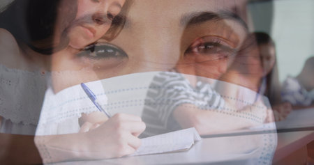 Digital composition of asian woman wearing face mask against college student studying at college. education and health concept.の写真素材