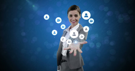Interacting with digital social network icons, businesswoman in suit smiling confidently. Networking, technology, professional, communication, connectionの写真素材