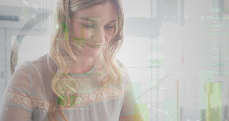 Image of statistics and data processing over businesswoman using smartphone. global business, data processing and technology concept digitally generated image.の写真素材