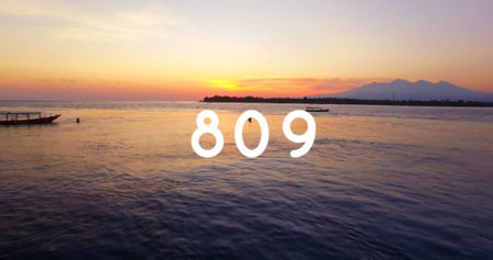 Digital image of the number in bold white text over a scenic sunset by the water. the composition...