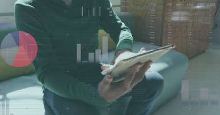 Statistical data processing against man using digital tablet at office. global business and...