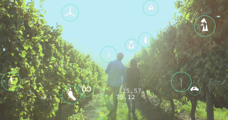 Image of digital icons and data processing over people embracing on field. global digital interface, data processing and technology concept digitally generated image.の写真素材