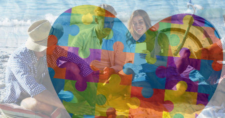 Image of colorful puzzle pieces heart over happy people on the beach. . autism, learning...