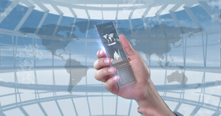 Hand holding futuristic transparent smartphone displaying global data and analytics. Technology,...