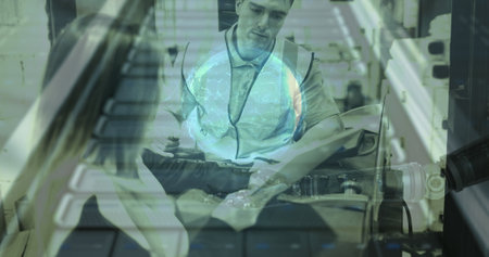 Warehouse worker in safety vest operating machinery, focusing on task at hand. Logistics, industrial, laborer, equipment, transportation, manufacturingの写真素材