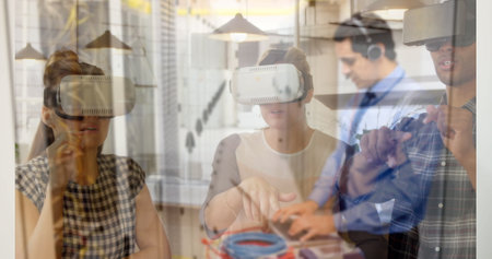 Virtual reality technology over diverse people interacting in modern office. teamwork,...