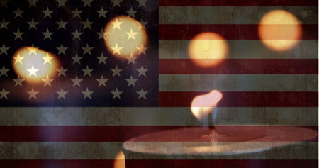 Digital composite of american flag against slowly burning down candles being blown out in the...