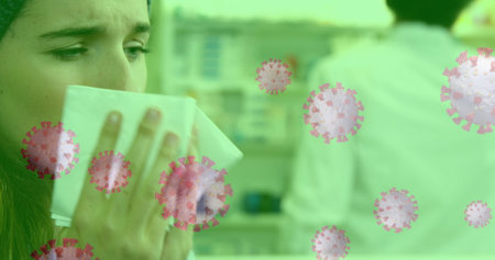 Woman in pharmacy sneezing into tissue with virus particles overlayed. Health, illness, hygiene,...