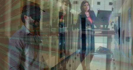 Man using virtual reality headset over businesswoman working in data center. Technology, innovation,...
