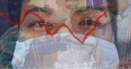 Children wearing masks celebrating birthday with cake, stock market graph overlay. Celebration, pandemic, finance, economy, birthday party, investingの写真素材