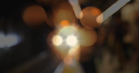 Image of glowing spots of light flickering over out of focus train platform. Modern world and urban...