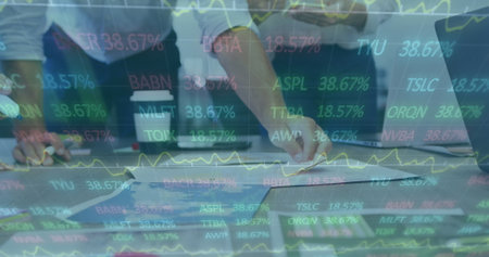 Image of interface showing data and statistics with business colleagues brainstorming in office. global communication technology digital interface concept, digitally generated image.の写真素材