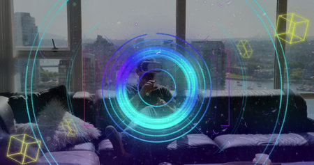 Colorful light trails and scope scanning over caucasian man gesturing while wearing vr headset....