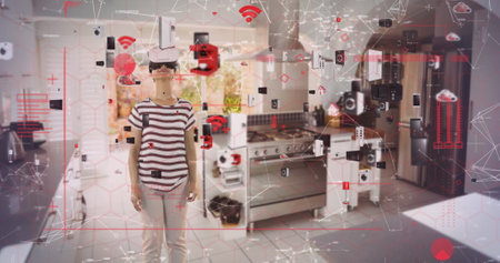 Image of data processing with digital icons over woman wearing vr headset in kitchen. global technology, connections and digital interface concept digitally generated image.の写真素材