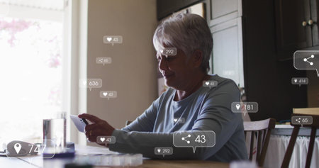 Image of social media icons and numbers on banners over senior woman using smartphone. global networking, social media, technology and digital interface concept digitally generated image.の写真素材