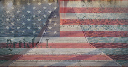 Constitution text and american flag against low section of caucasian woman walking on wooden pier....