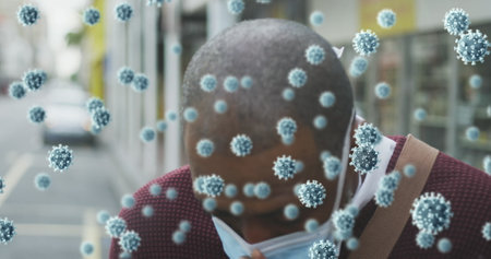Image of covid 19 cells over man wearing face mask. global covid 19 pandemic concept digitally...