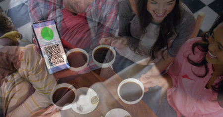 Woman holding a smartphone with qr code on screen against group of friends having coffee together. covid-19 vaccination certificate and health pass conceptの写真素材