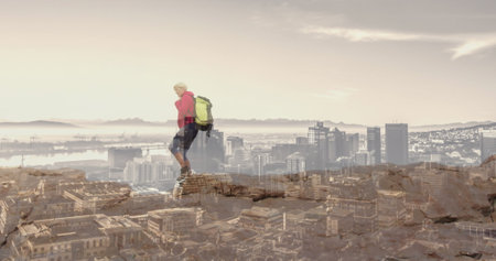 Composite of caucasian senior woman hiking on mountain, and modern cityscape. healthy retirement, fitness and wellbeing concept digitally generated image.の写真素材