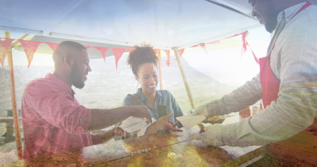 Composite of happy african american couple buying takeaway food, and mountain countryside. health,...