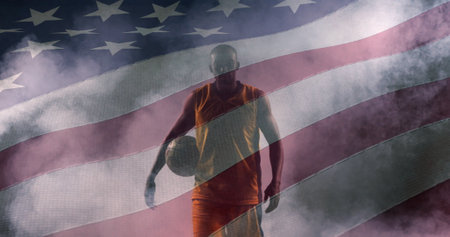 Image of flag of united states of america over african american basketball player. american patriotism and independence concept digitally generated image.の写真素材