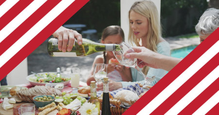 Image of american flag over family during dinner drinking wine. patriotism and celebration concept digitally generated image.の写真素材