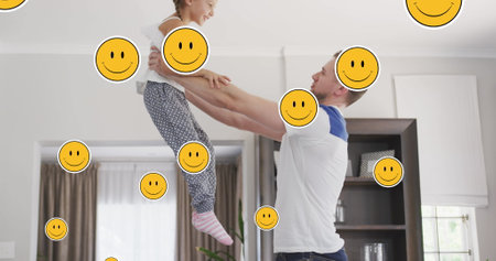 Image of smiley faces over happy caucasian father and daughter jumping at home. family, domestic...
