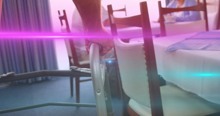 Image of coloured lights moving over senior man in dining room using walking frame. retirement,...