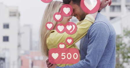 Image of heart icons floating over happy caucasian couple embracing. social media and communication...