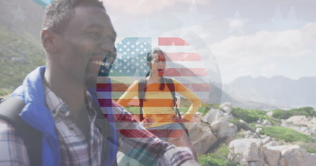 Image of smiling diverse couple hiking in mountains. Celebration concept digitally generated image.