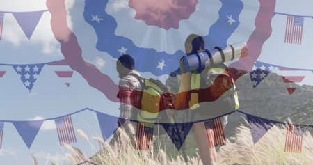 Image of american flag over smiling diverse couple hiking in mountains. patriotism and celebration...