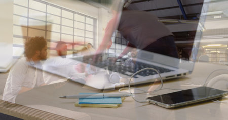 Image of laptop over group of business people in office. global business, finances, connections and...