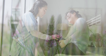 Image of asian doctor treating female patient over plants. medical and healthcare services concept...