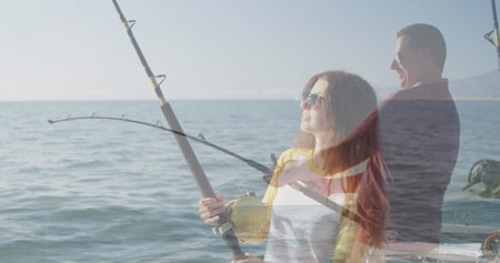 Image of caucasian woman fishing with caucasian man fishing and sea. hobby and lifestyle concept...