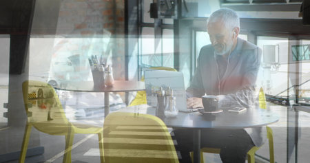 Image of senior caucasian businessman using laptop in office. global business, finances, connections...