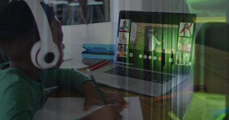 Image of african american schoolboy on laptop online learning over computer servers. global...