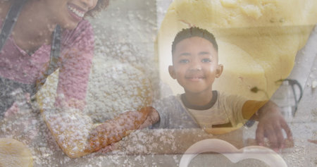Image of happy african american mother and son baking over dough and cookies. family spending time at home concept digitally generated image.の写真素材