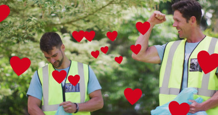 Image of red hearts over celebrating caucasian group picking up rubbish in countryside. eco...