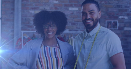 Image of spots of lights over diverse male and female tailors. global networks, business and connections concept digitally generated image.の写真素材