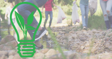 Image of light bulb icon over diverse people cleaning in forest. earth day and celebration, concept...