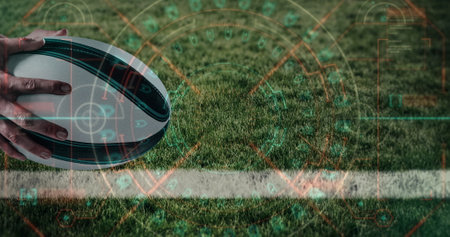 Digital interface with data processing against close up of hand holding a rugby ball. sports and competition conceptの写真素材