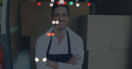 Image of road at night over happy caucasian male deliverer with cartons. global business and digital interface concept digitally generated image.の写真素材