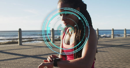 6g text over blue neon scanner against african american fit woman using smartwatch on the promenade. sports, fitness and technology conceptの写真素材